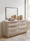 Hasbrick King Panel Headboard with Mirrored Dresser, Chest and 2 Nightstands